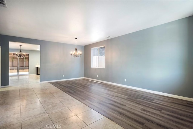 30574 Saddlehorn Way, Menifee, CA 92584 - empty room featuring a chandelier and wood finished floors