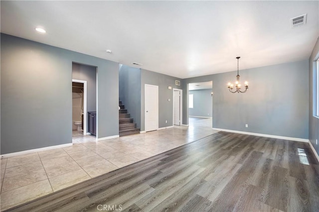 30574 Saddlehorn Way, Menifee, CA 92584 - empty room with stairway, a chandelier, wood finished floors, and recessed lighting