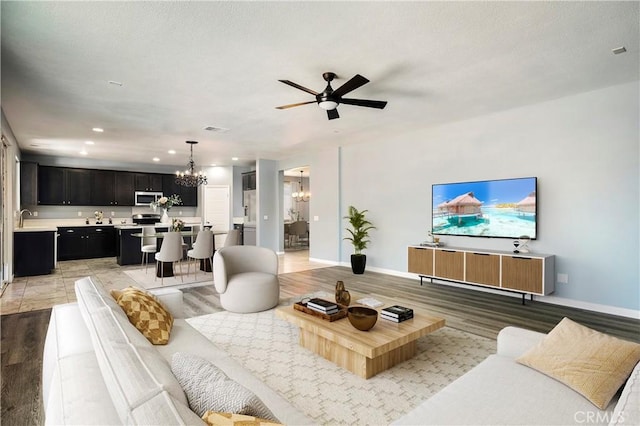 30574 Saddlehorn Way, Menifee, CA 92584 - living area featuring a chandelier, a ceiling fan, light wood-type flooring, and recessed lighting