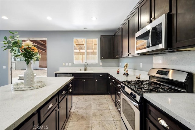 30574 Saddlehorn Way, Menifee, CA 92584 - kitchen featuring stainless steel appliances, light stone countertops, recessed lighting, dark brown cabinetry, and light tile patterned flooring