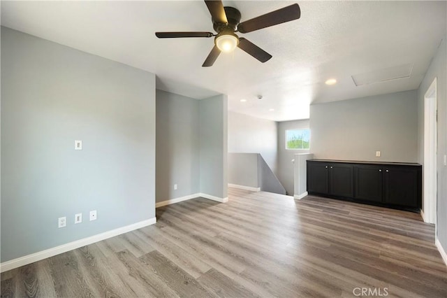 30574 Saddlehorn Way, Menifee, CA 92584 - unfurnished living room with wood finished floors, ceiling fan, attic access, and recessed lighting