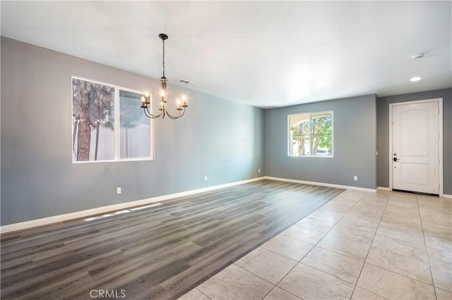 30574 Saddlehorn Way, Menifee, CA 92584 - empty room with a chandelier and light wood-style flooring