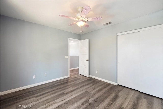 30574 Saddlehorn Way, Menifee, CA 92584 - unfurnished bedroom featuring wood finished floors, a closet, and a ceiling fan