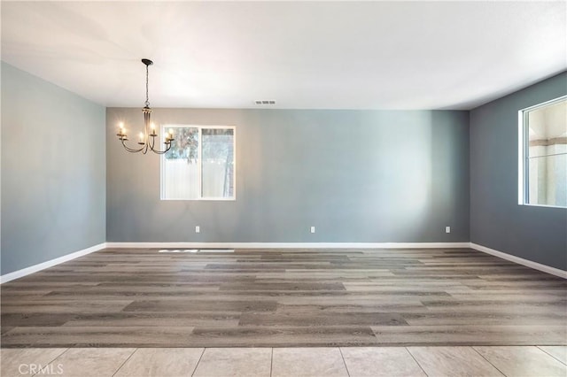 30574 Saddlehorn Way, Menifee, CA 92584 - spare room with plenty of natural light, a chandelier, and wood finished floors