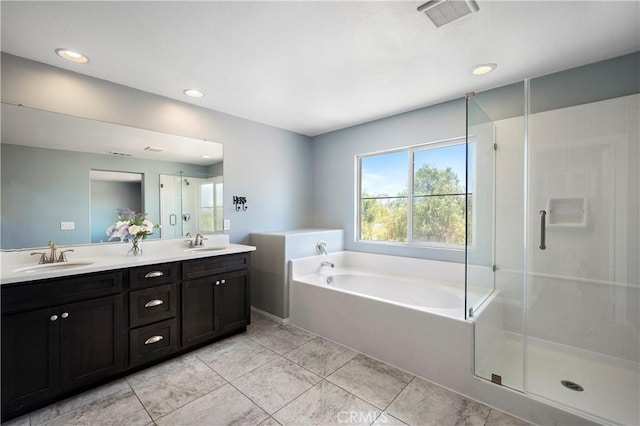 30574 Saddlehorn Way, Menifee, CA 92584 - bathroom with double vanity, a garden tub, a shower stall, tile patterned floors, and recessed lighting