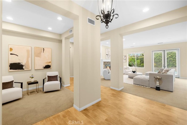 221 Grand Oaks Dr, Glendora, CA 91741 - hallway with light wood-style flooring, a chandelier, recessed lighting, baseboards, and light carpet