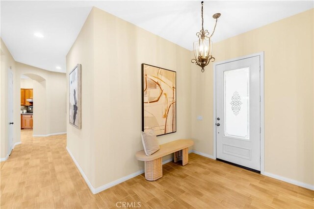 221 Grand Oaks Dr, Glendora, CA 91741 - foyer entrance featuring light wood finished floors, arched walkways, baseboards, a chandelier, and recessed lighting