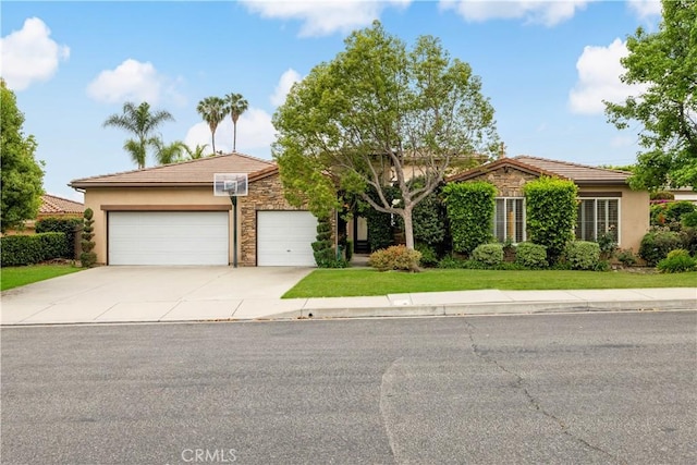 221 Grand Oaks Dr, Glendora, CA 91741 - view of front of home with stone siding, an attached garage, driveway, a tiled roof, and stucco siding
