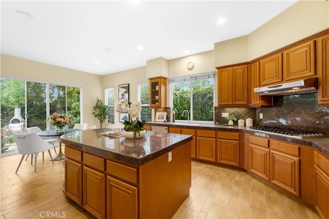 221 Grand Oaks Dr, Glendora, CA 91741 - kitchen featuring under cabinet range hood, appliances with stainless steel finishes, a sink, brown cabinets, and tasteful backsplash