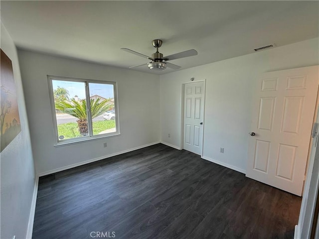 10328 Shoshone Ave, Riverside, CA 92503 - unfurnished bedroom with dark wood-style floors, baseboards, and ceiling fan