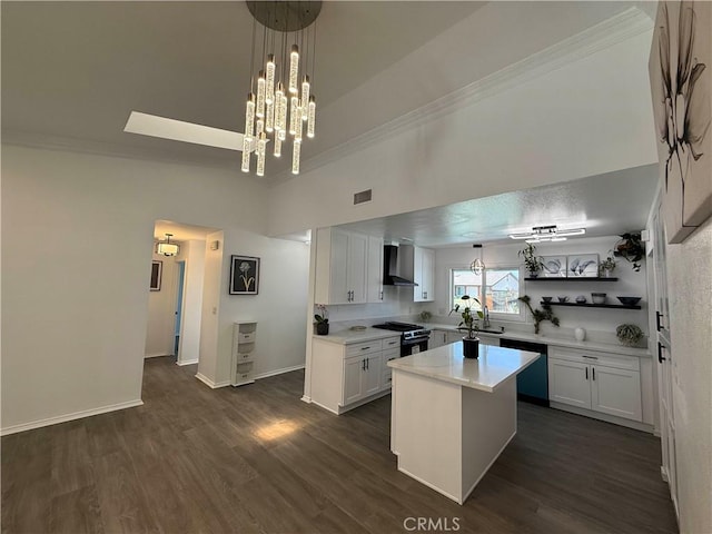 10328 Shoshone Ave, Riverside, CA 92503 - kitchen with wall chimney range hood, gas range, crown molding, white cabinetry, and light countertops