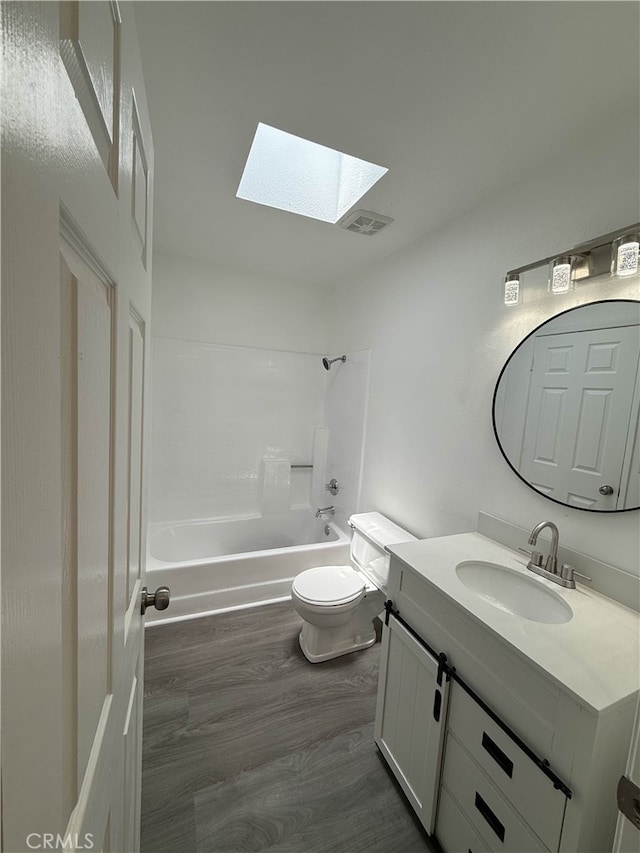10328 Shoshone Ave, Riverside, CA 92503 - bathroom with a skylight, toilet, vanity,  shower combination, and wood finished floors