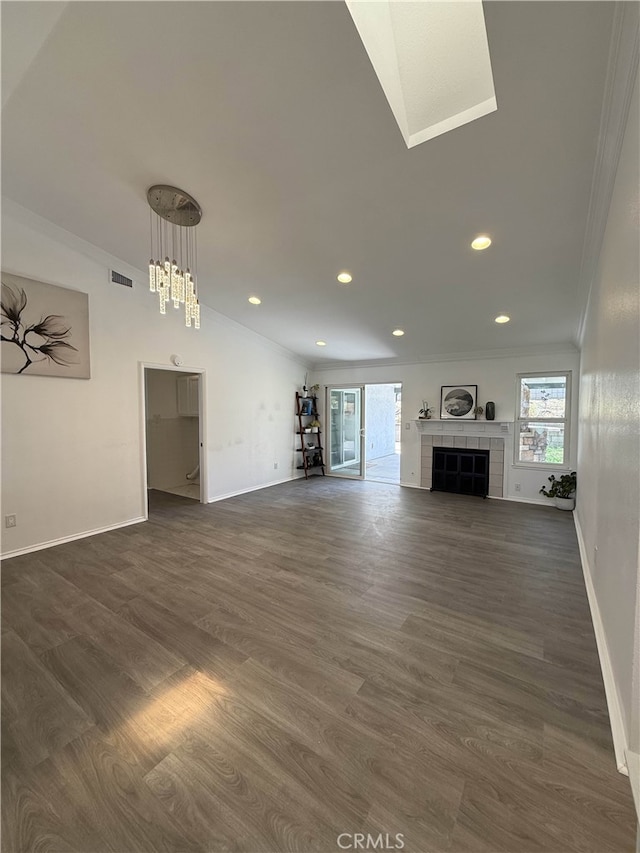 10328 Shoshone Ave, Riverside, CA 92503 - unfurnished living room with crown molding, baseboards, recessed lighting, dark wood-style flooring, and a tiled fireplace