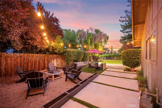 3066 Claret Cir, Atwater, CA 95301 - patio terrace at dusk with a patio area and an outdoor living space with a fire pit