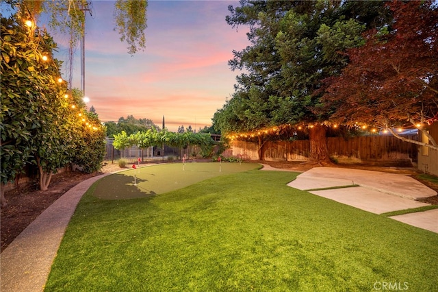 3066 Claret Cir, Atwater, CA 95301 - yard at dusk featuring an area to practice putting and a patio area