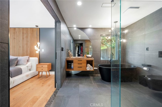 3066 Claret Cir, Atwater, CA 95301 - bathroom featuring vanity, tile walls, a freestanding bath, a shower stall, and recessed lighting
