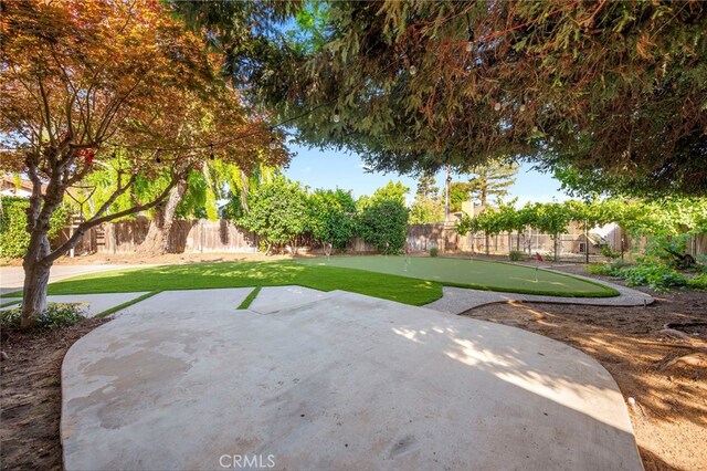 3066 Claret Cir, Atwater, CA 95301 - fenced backyard featuring an area to practice putting and a patio
