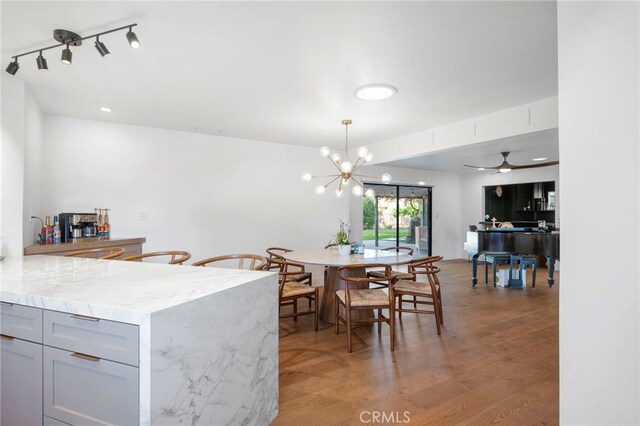 3066 Claret Cir, Atwater, CA 95301 - dining room featuring light wood-type flooring, a chandelier, and a ceiling fan