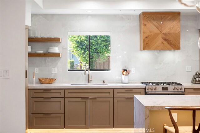 3066 Claret Cir, Atwater, CA 95301 - kitchen with a sink, stainless steel gas range, light countertops, and open shelves