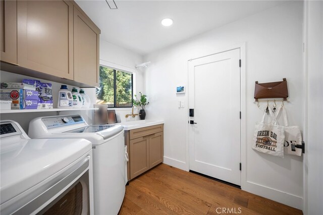 3066 Claret Cir, Atwater, CA 95301 - washroom with cabinet space, washing machine and dryer, light wood-style floors, and recessed lighting