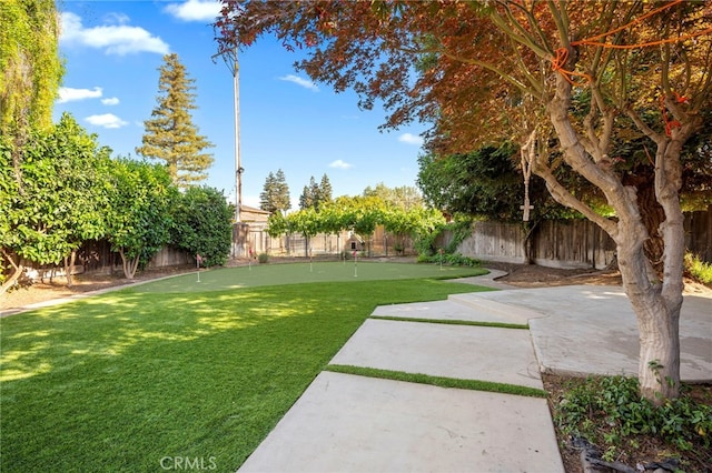3066 Claret Cir, Atwater, CA 95301 - fenced backyard featuring a putting area and a patio