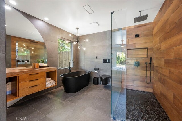 3066 Claret Cir, Atwater, CA 95301 - bathroom featuring tile walls, a tile shower, vanity, tile patterned flooring, and a freestanding bath