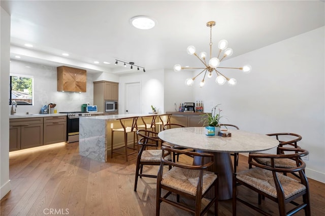 3066 Claret Cir, Atwater, CA 95301 - dining area featuring light wood-style floors, a chandelier, track lighting, and recessed lighting