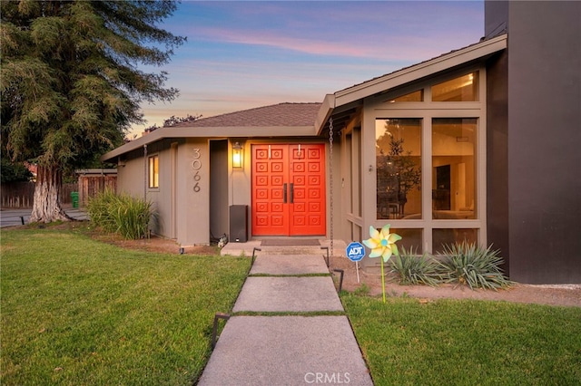 3066 Claret Cir, Atwater, CA 95301 - exterior entry at dusk with a yard