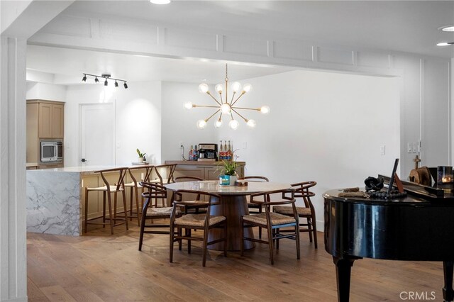3066 Claret Cir, Atwater, CA 95301 - dining room featuring light wood-type flooring and a chandelier