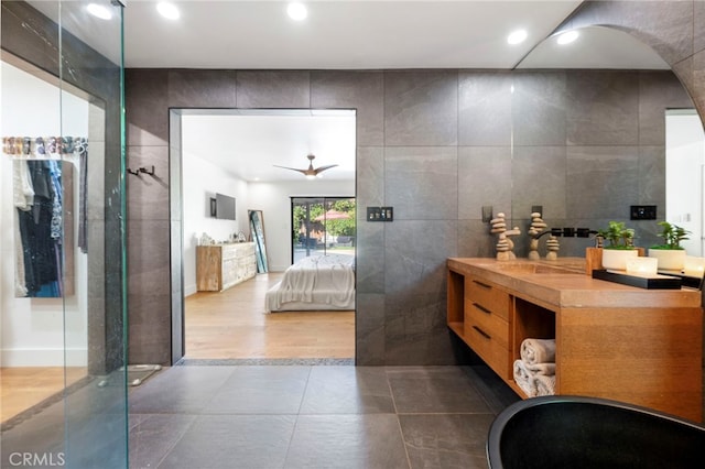 3066 Claret Cir, Atwater, CA 95301 - ensuite bathroom featuring vanity, tile walls, recessed lighting, ceiling fan, and a shower with door