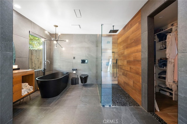 3066 Claret Cir, Atwater, CA 95301 - full bath featuring tile walls, walk in shower, a freestanding bath, a spacious closet, and vanity