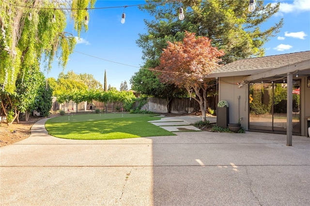 3066 Claret Cir, Atwater, CA 95301 - fenced backyard featuring a putting green and a patio