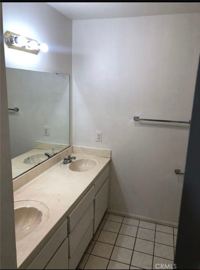 134281/2 Village Dr Unit 1/2, Cerritos, CA 90703 - bathroom featuring double vanity, tile patterned floors, and baseboards