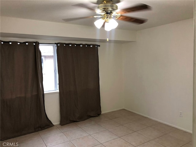 134281/2 Village Dr Unit 1/2, Cerritos, CA 90703 - spare room featuring a ceiling fan, light tile patterned floors, and baseboards