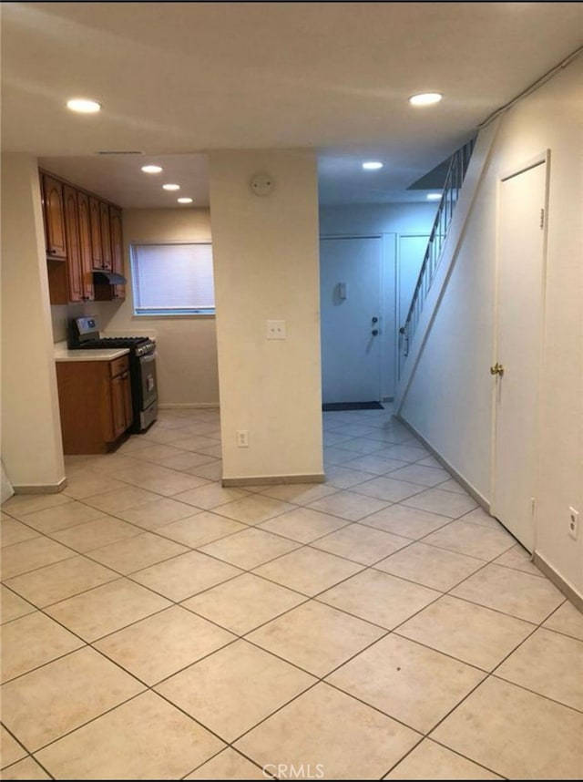 134281/2 Village Dr Unit 1/2, Cerritos, CA 90703 - kitchen with stainless steel gas range oven, recessed lighting, light countertops, baseboards, and under cabinet range hood