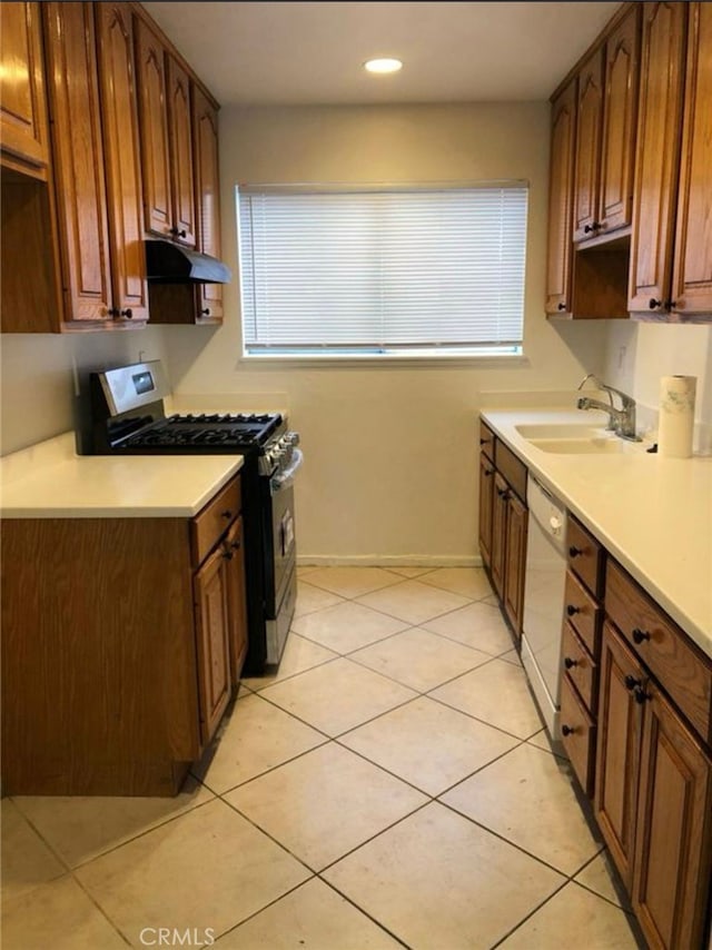 134281/2 Village Dr Unit 1/2, Cerritos, CA 90703 - kitchen with gas stove, a sink, white dishwasher, under cabinet range hood, and light countertops