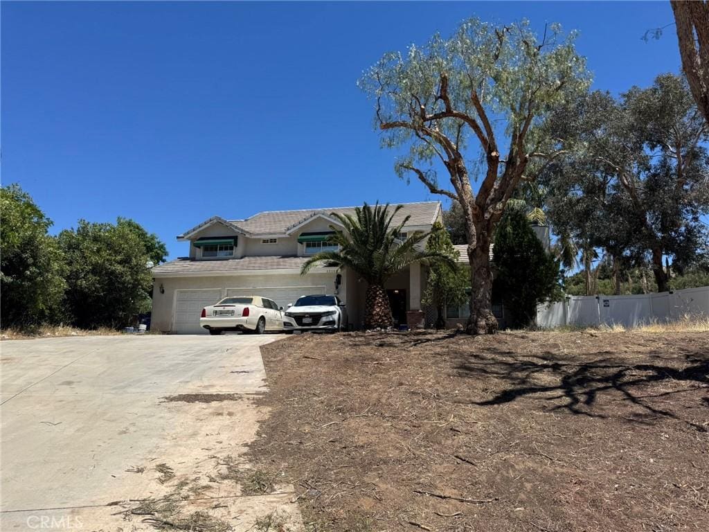 33344 Rose Ave, Acton, CA 93510 - view of front facade with driveway, a tiled roof, stucco siding, and an attached garage