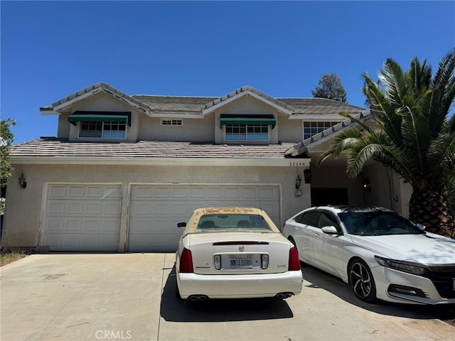 33344 Rose Ave, Acton, CA 93510 - view of front of house featuring driveway, a garage, stucco siding, and a tiled roof