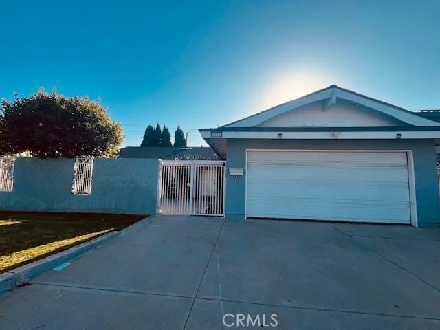 9791 Lee St, Cypress, CA 90630 - single story home featuring concrete driveway, stucco siding, a gate, and a garage