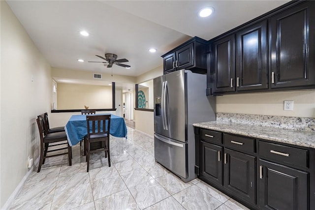 9791 Lee St, Cypress, CA 90630 - kitchen featuring dark cabinets, stainless steel fridge with ice dispenser, a ceiling fan, light marble finish flooring, and recessed lighting