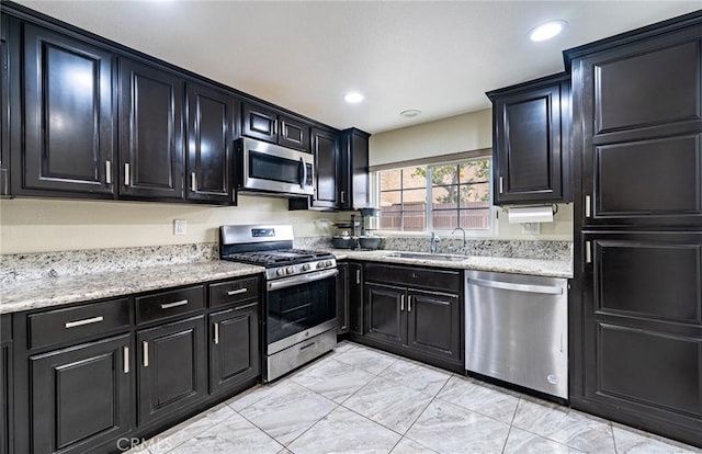 9791 Lee St, Cypress, CA 90630 - kitchen featuring stainless steel appliances, a sink, dark cabinetry, light marble finish flooring, and recessed lighting