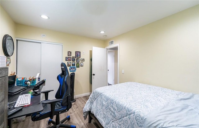 9791 Lee St, Cypress, CA 90630 - bedroom with light wood-style floors, recessed lighting, a desk, baseboards, and a closet