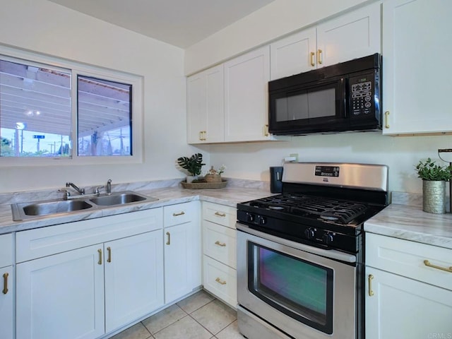 3304 E St, San Diego, CA 92102 - kitchen with black microwave, stainless steel gas range, a sink, light countertops, and white cabinets