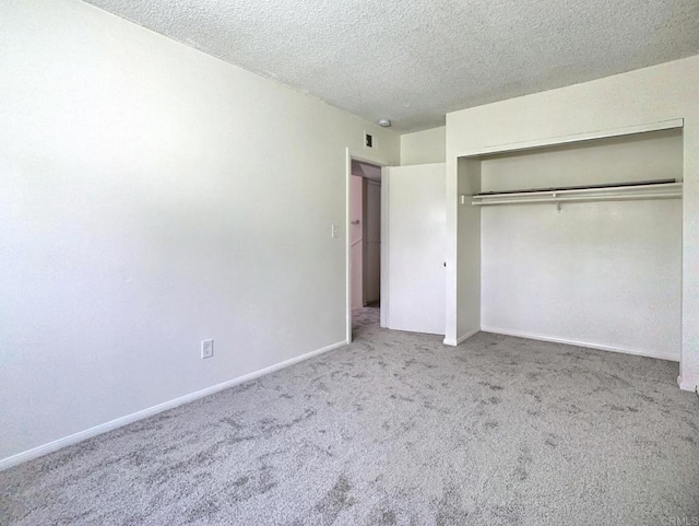 3304 E St, San Diego, CA 92102 - unfurnished bedroom featuring carpet floors, a textured ceiling, a closet, and baseboards