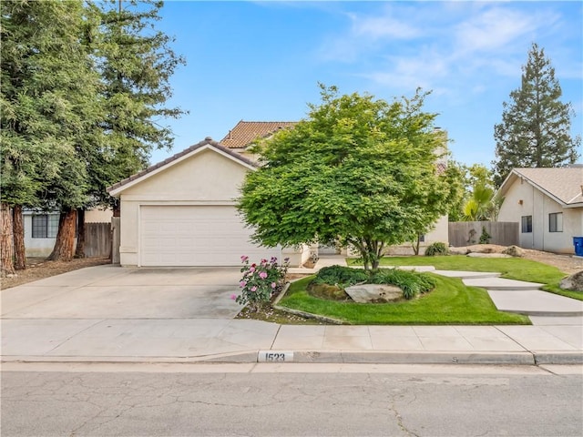 1523 E Pryor Dr, Fresno, CA 93720 - view of front facade with driveway, stucco siding, an attached garage, and a tile roof