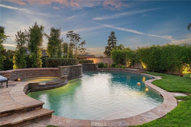 1921 Windward Ln, Newport Beach, CA 92660 - pool at dusk with a fenced backyard, a pool with connected hot tub, and a patio area