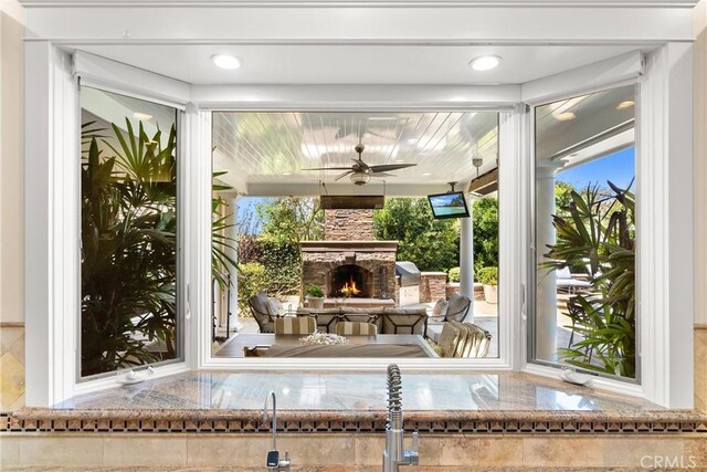 1921 Windward Ln, Newport Beach, CA 92660 - view of patio with an outdoor stone fireplace and a ceiling fan