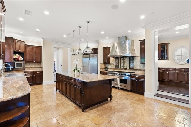 1921 Windward Ln, Newport Beach, CA 92660 - kitchen featuring wall chimney exhaust hood, built in appliances, a sink, decorative backsplash, and ornamental molding