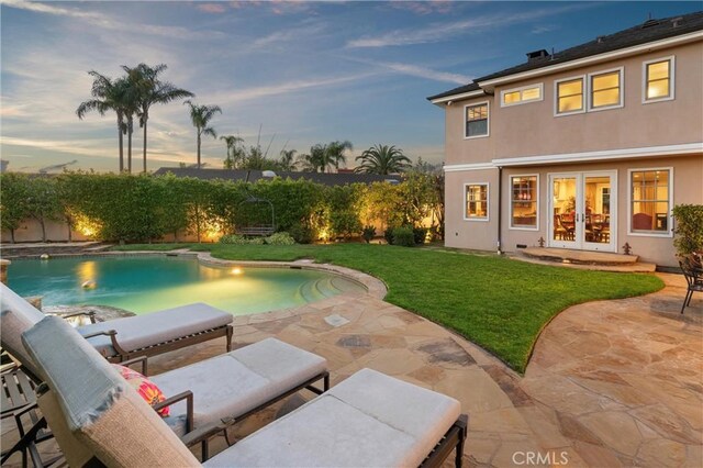 1921 Windward Ln, Newport Beach, CA 92660 - pool at dusk featuring french doors and a patio area
