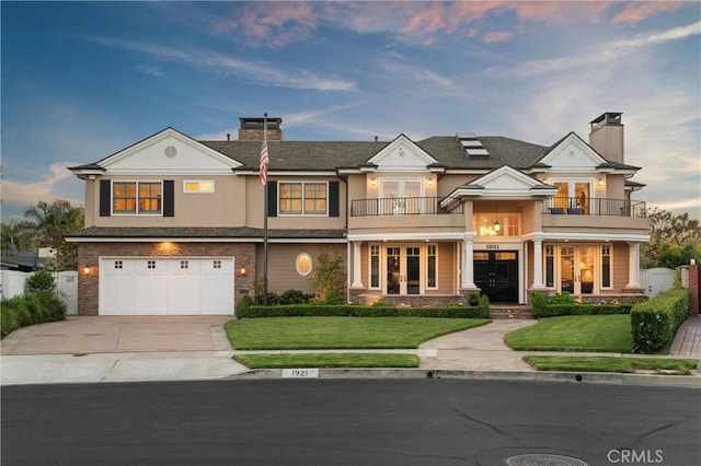 1921 Windward Ln, Newport Beach, CA 92660 - view of front of home featuring a balcony, french doors, a chimney, and concrete driveway